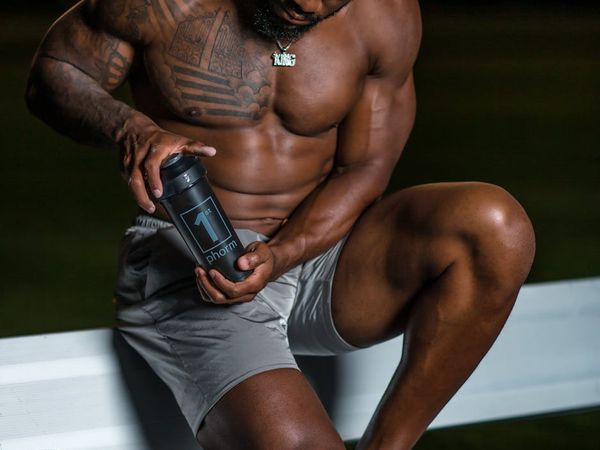 Man performing a controlled bodyweight exercise with intense focus.